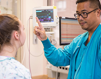 A care provider examining a patient's vision.