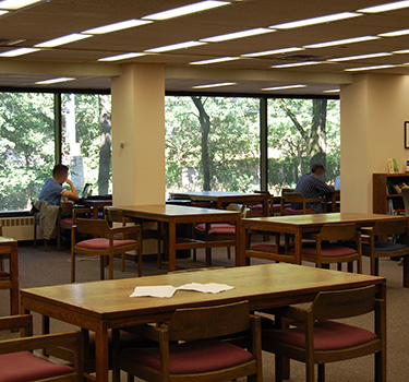 Large open area with wooden tables and chairs.