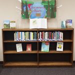 Bookshelf displaying the environmental health exhibit in the UW Health Sciences Library,