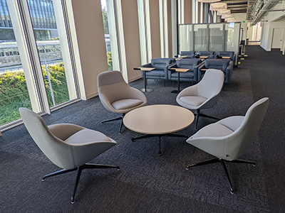 Four swivel chairs surrounding a small round table in the Cedar Lounge area.