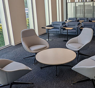 Circular table surrounded by four swivel chairs in the Cedar Lounge area