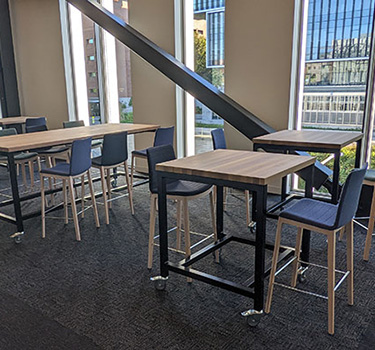 Tall tables and chairs in the Red Alder area